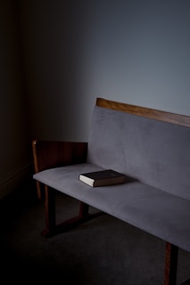 black book on gray sofa
