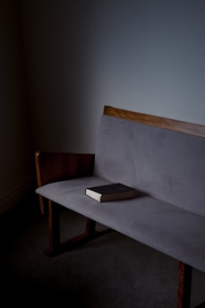 black book on gray sofa