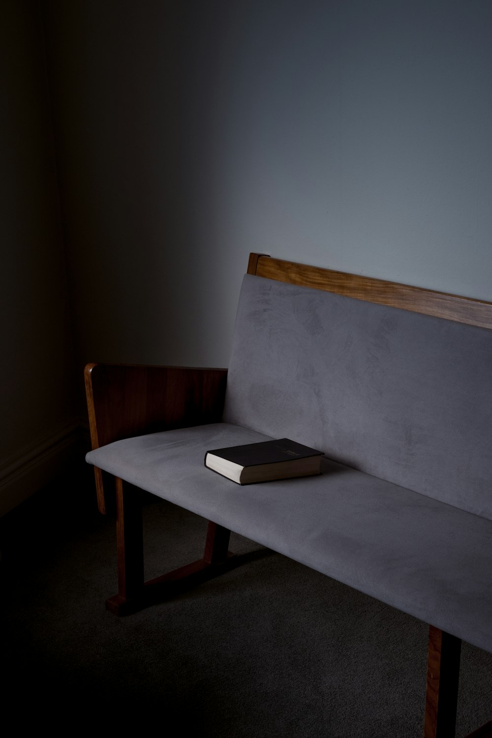 black book on gray sofa