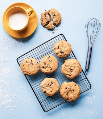 cookies on black grill beside yellow ceramic cup