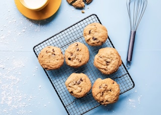 cookies on black grill beside yellow ceramic cup