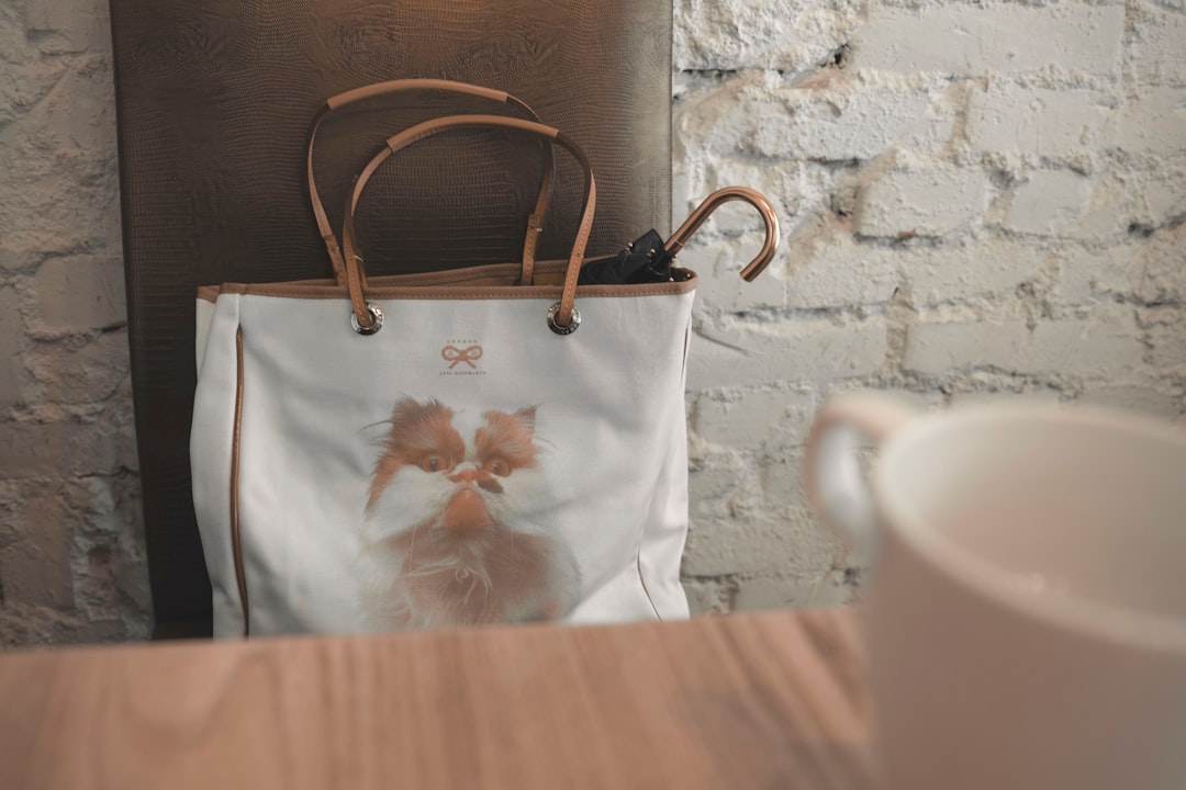 white and brown leather tote bag on chair