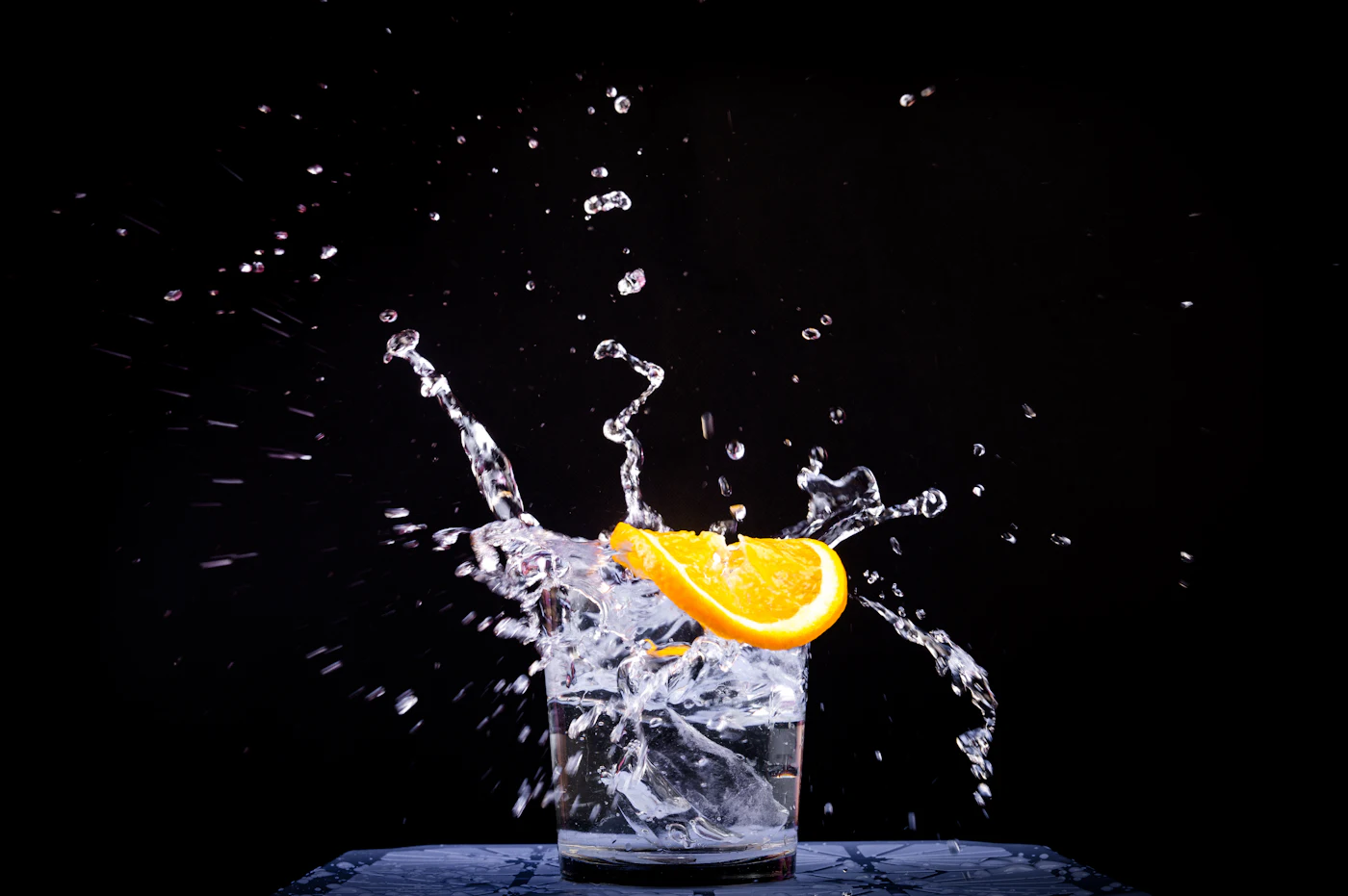 A glass of water with a slice of lemon