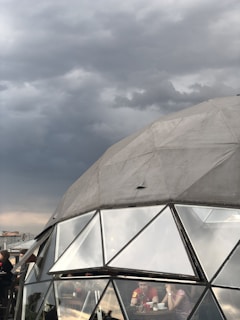 Time-lapse style visualization of a storm forming outside while the dome shields the area inside.