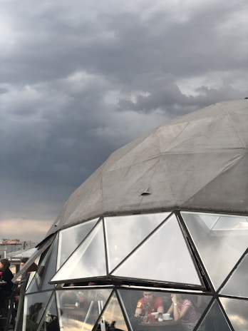 Time-lapse style visualization of a storm forming outside while the dome shields the area inside.