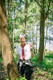 Portrait of the founder and executive director standing in a lush forest, symbolizing commitment to reforestation.