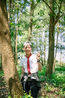 Portrait of the founder and executive director standing in a lush forest, symbolizing commitment to reforestation.