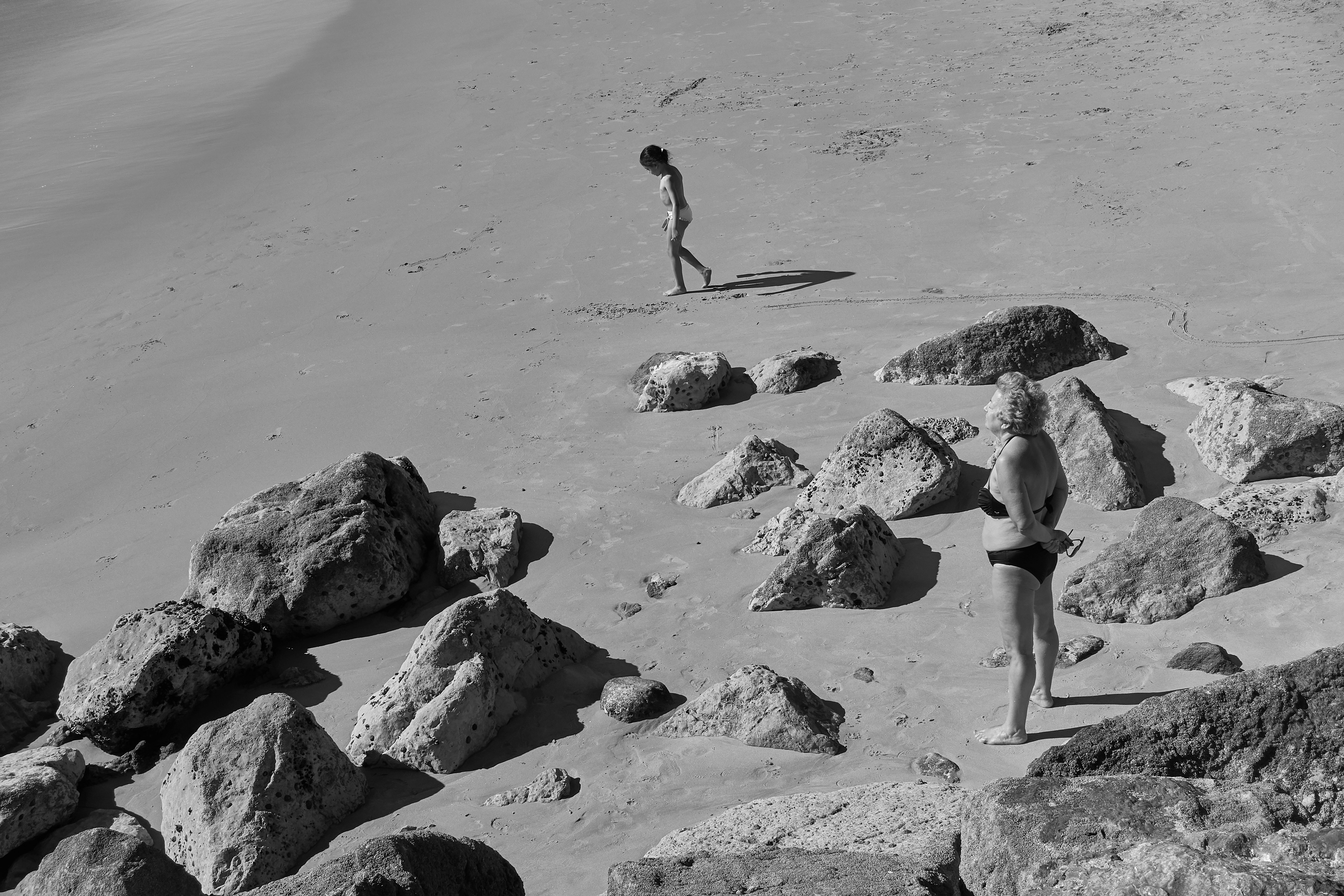grayscale photo of two person near body of water, 
