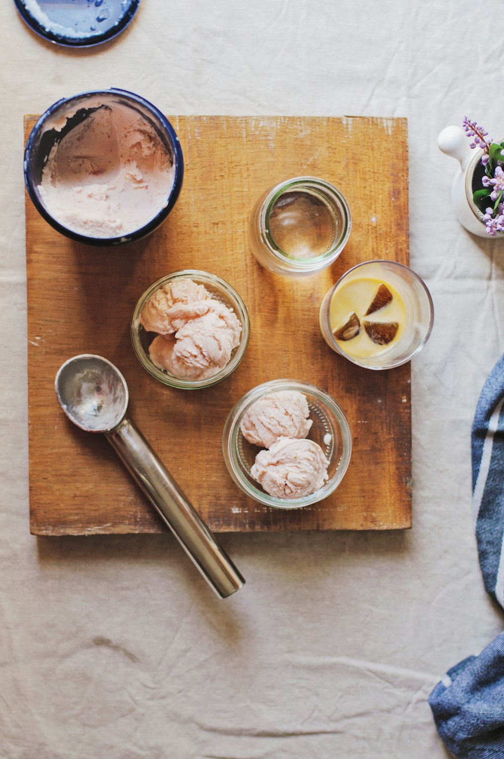 stainless steel ice cream scoop beside clear glass containers