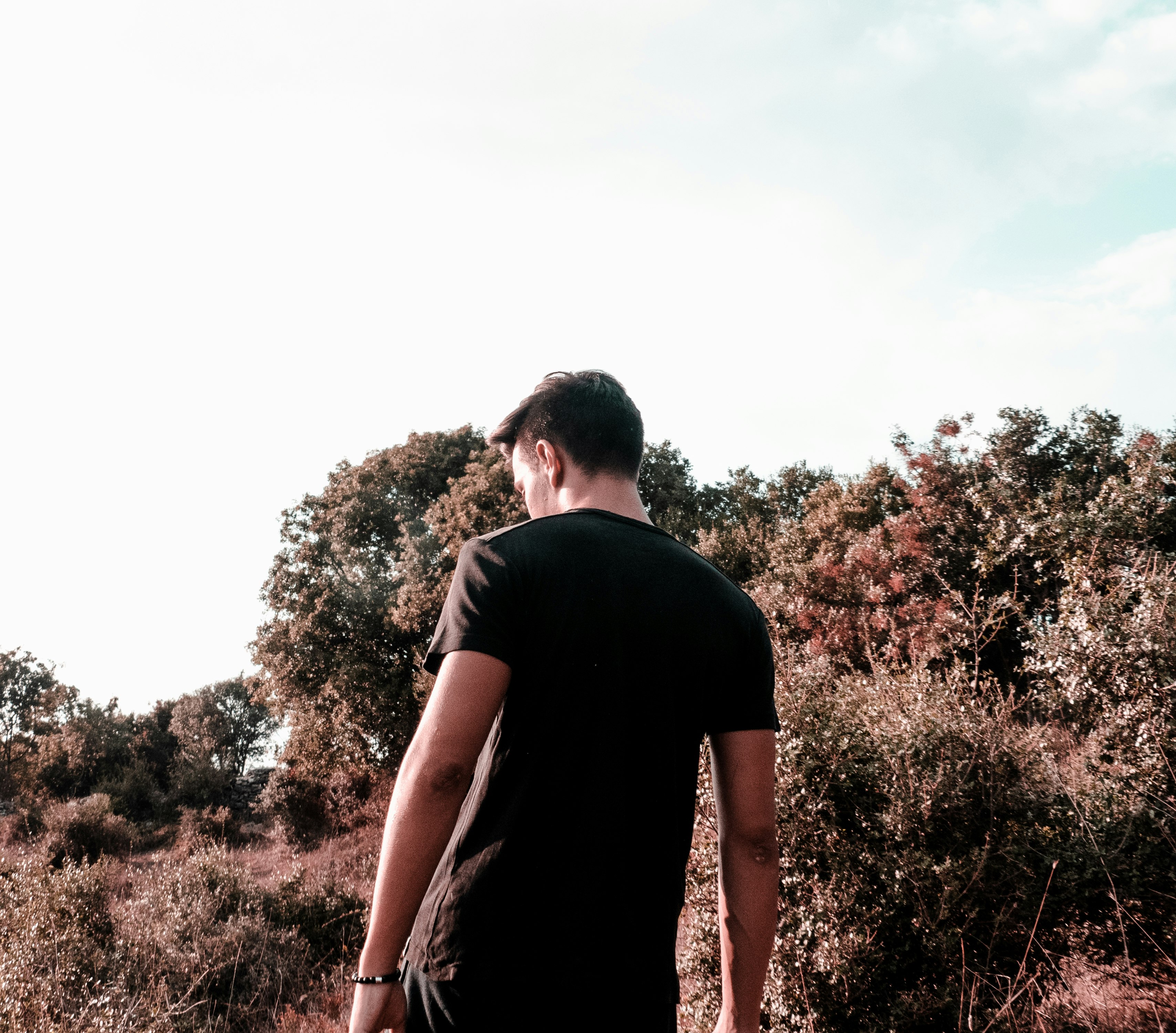 man walking near trees