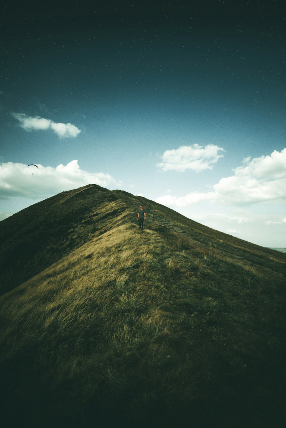 person on green grass mountain