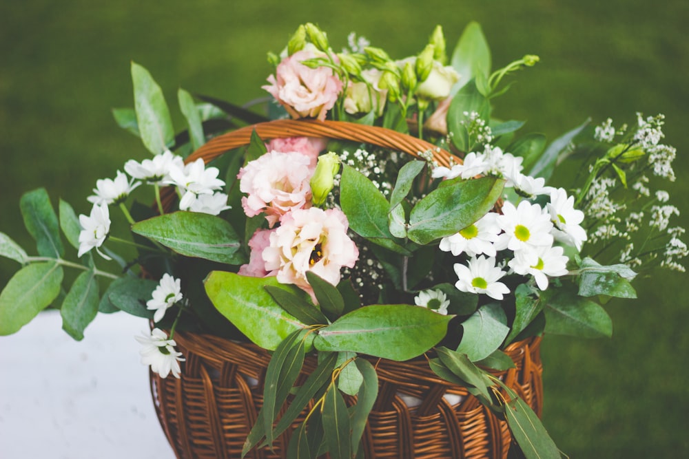 white and pink flowers in wicker basket