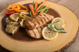 Grilled chicken with steamed vegetables on a clean white plate.