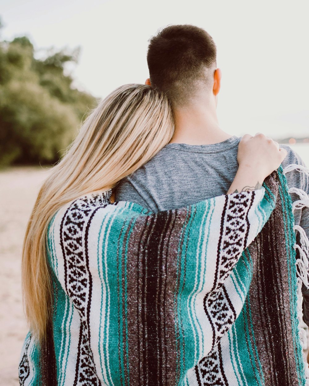 woman's hand on man's shoulder