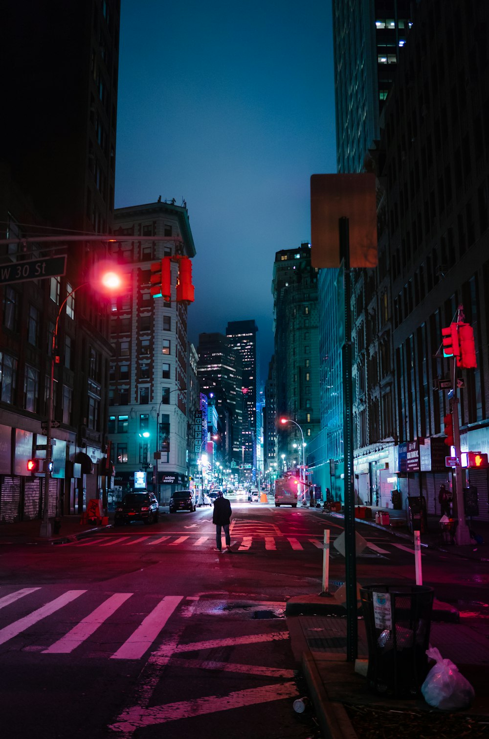 person standing center of road near buildings