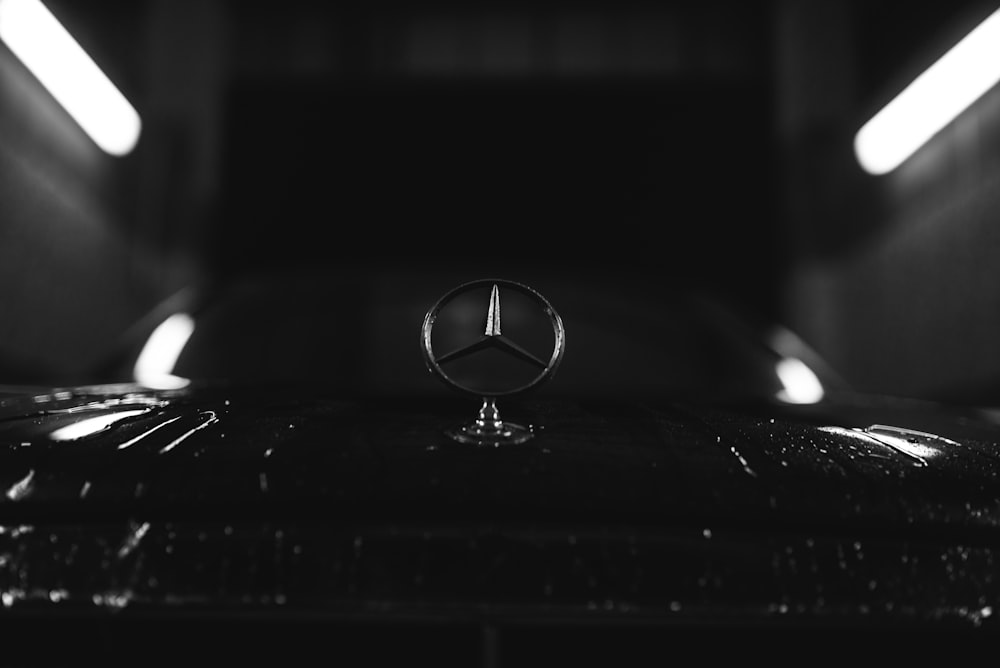 selective focus photography of Mercedes-Benz emblem