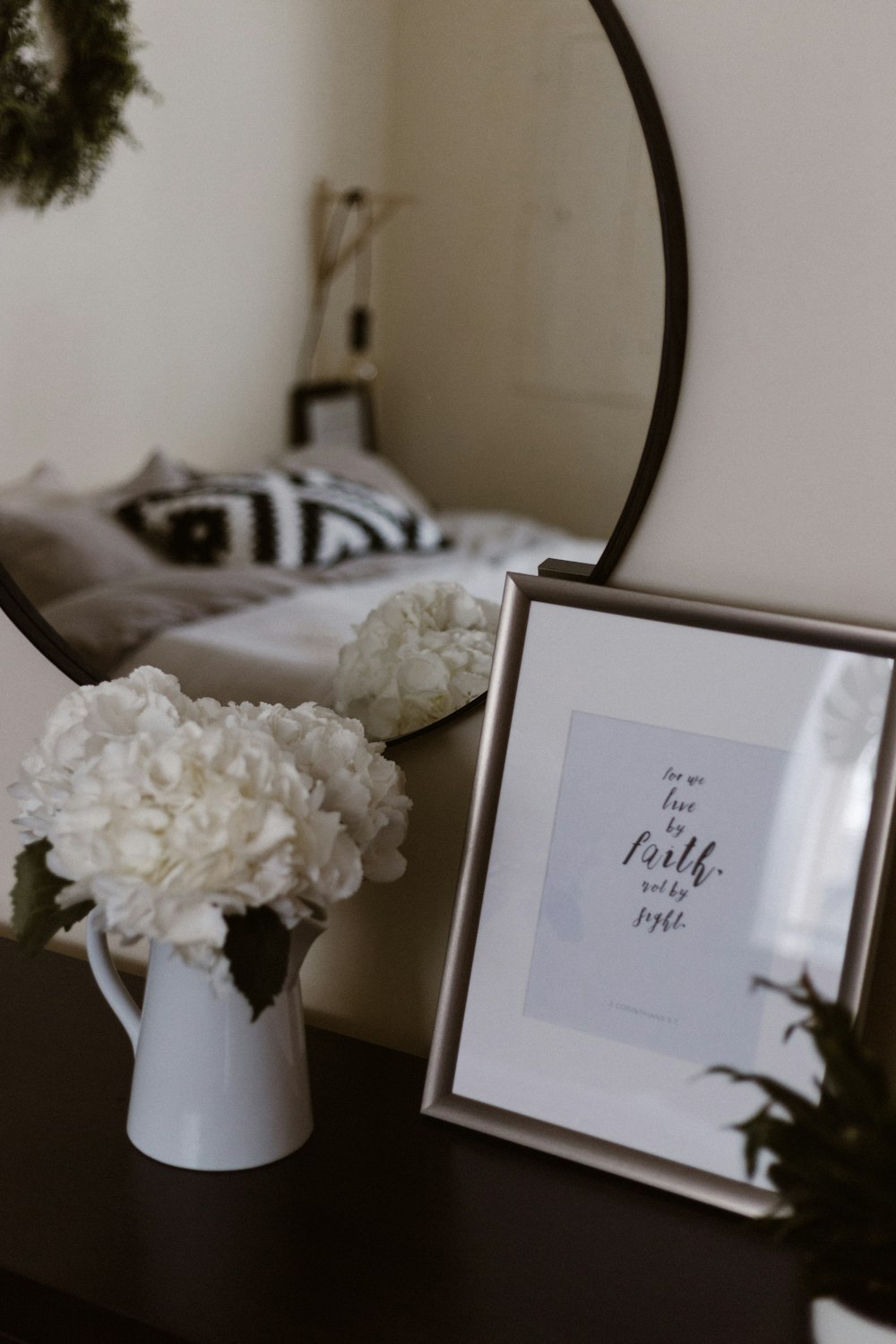 white potted flowers beside photo frame
