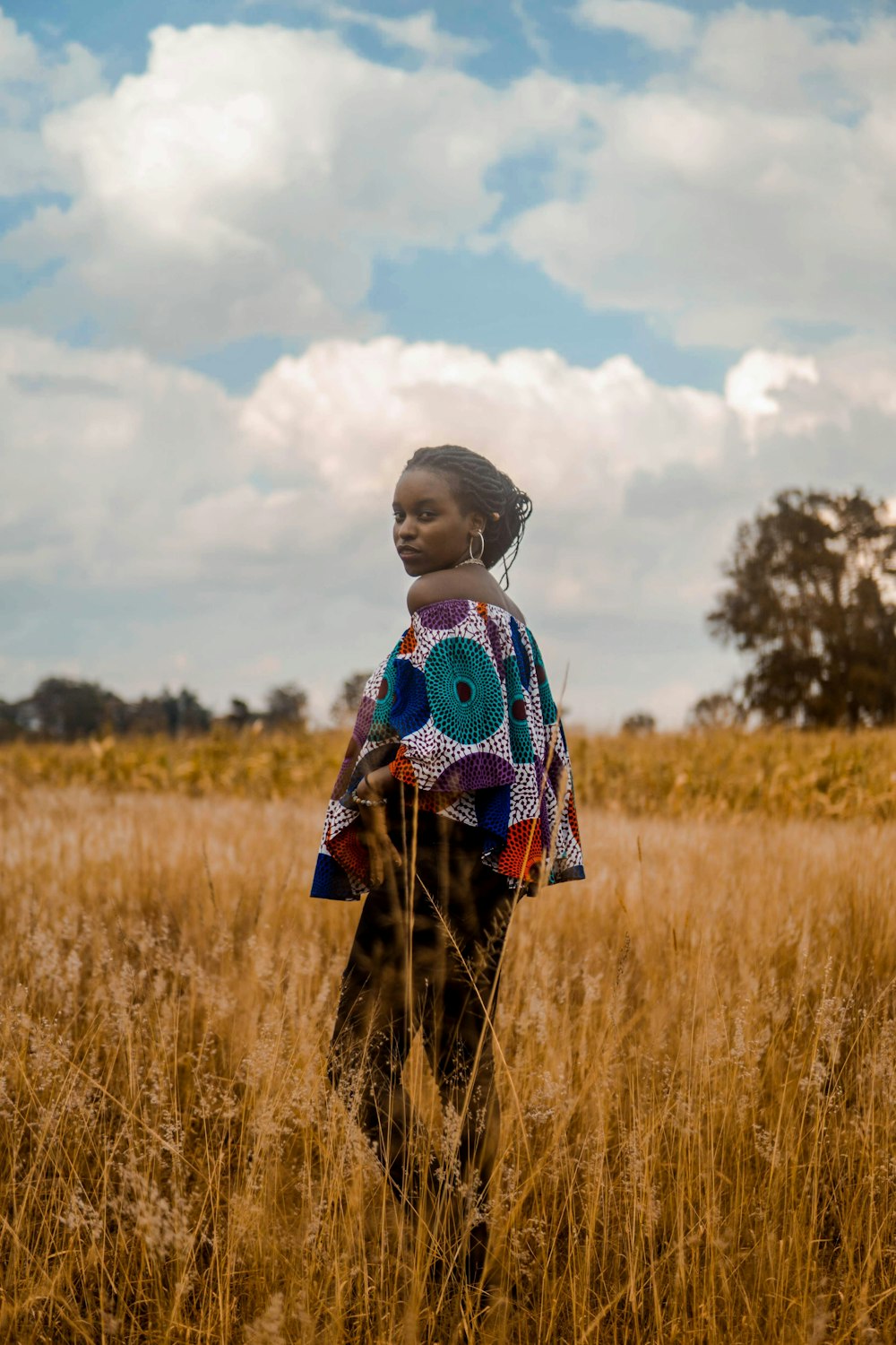 depth of field photography of woman surrounded by grass field