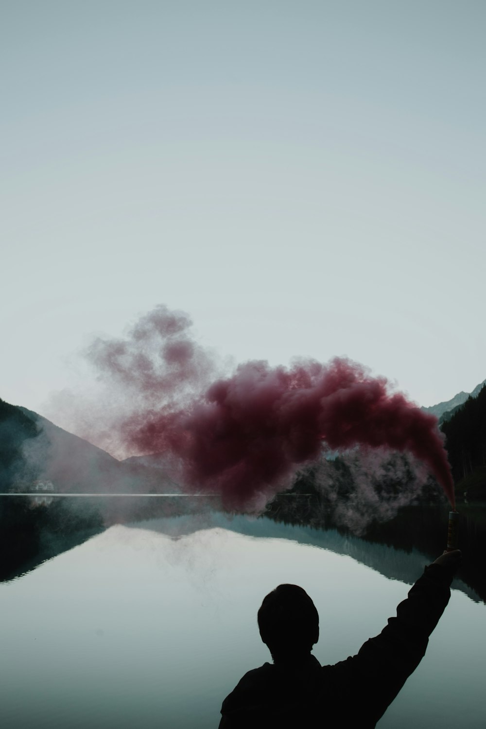 person spray red smoke