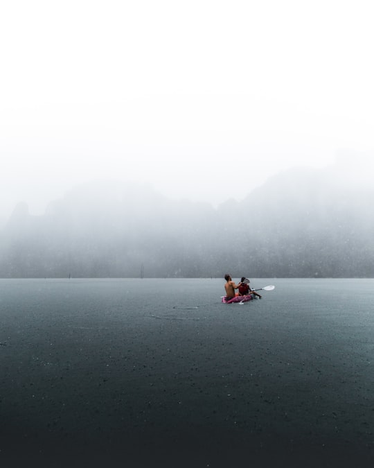 person in boat on body of water in Khao Sok National Park Thailand