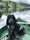 black dog sitting on boat on body of water