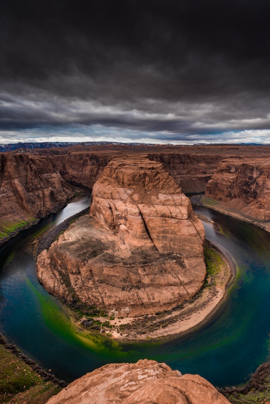 grey rock formation under gloomy sky in Glen Canyon National Recreation Area United States