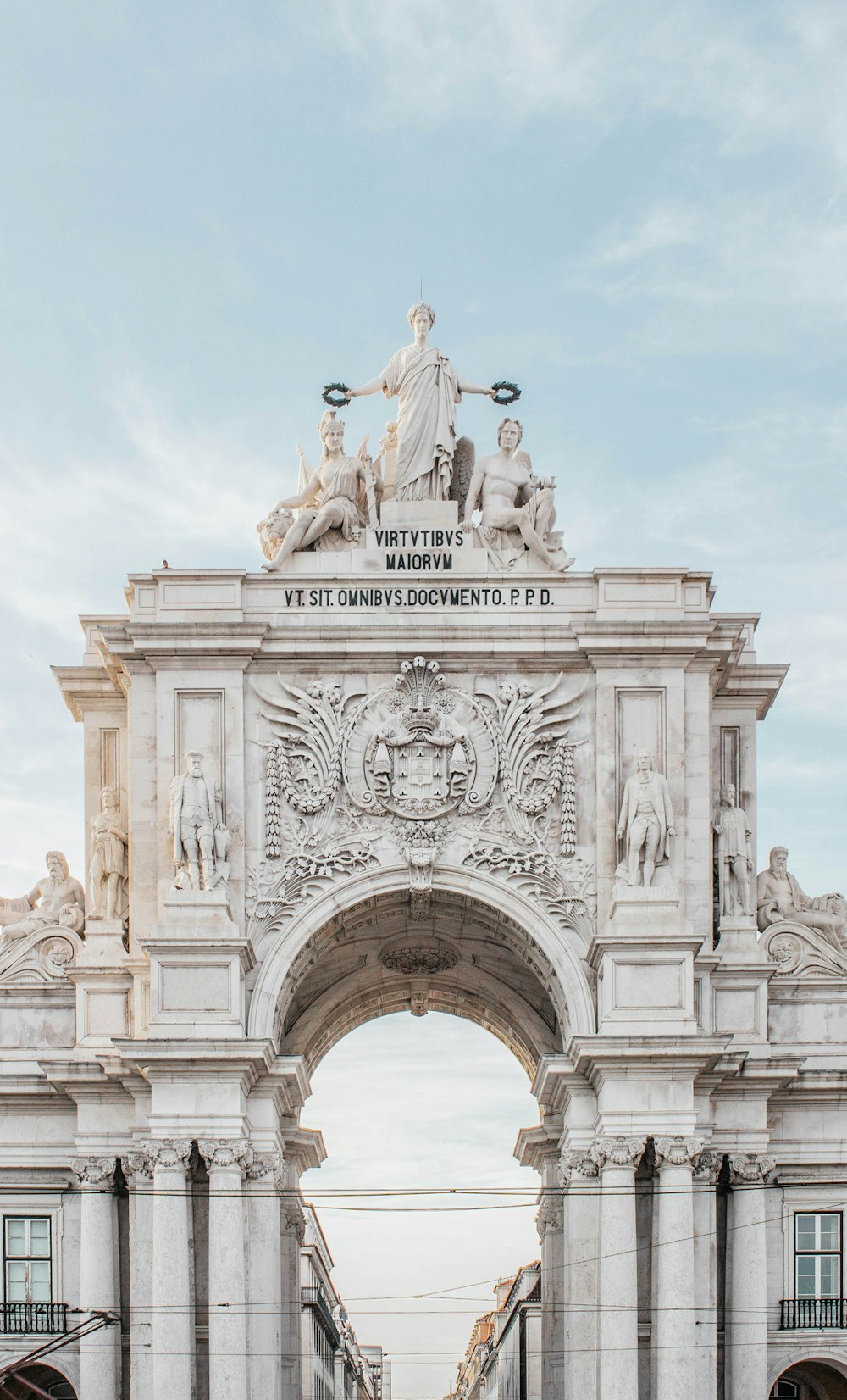 white concrete arch under blue sky