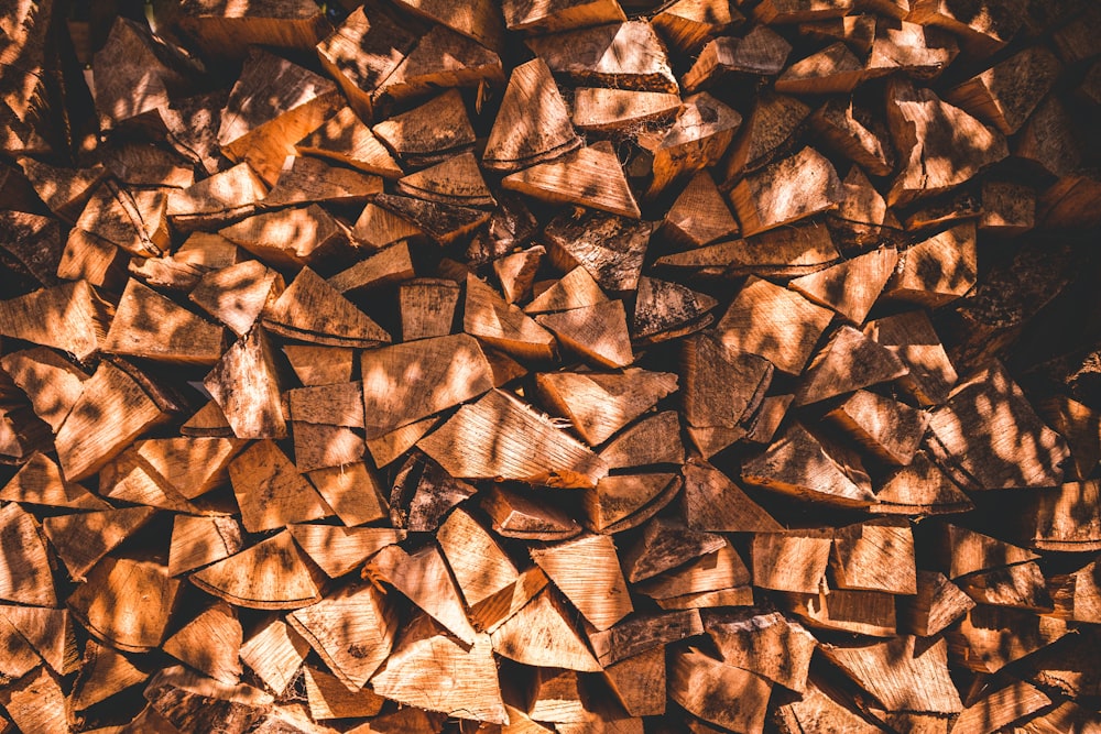 a pile of chopped wood sitting on top of a wooden floor
