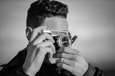 person holding SLR camera