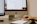 person holding white Apple Magic Mouse beside iMac and keyboard