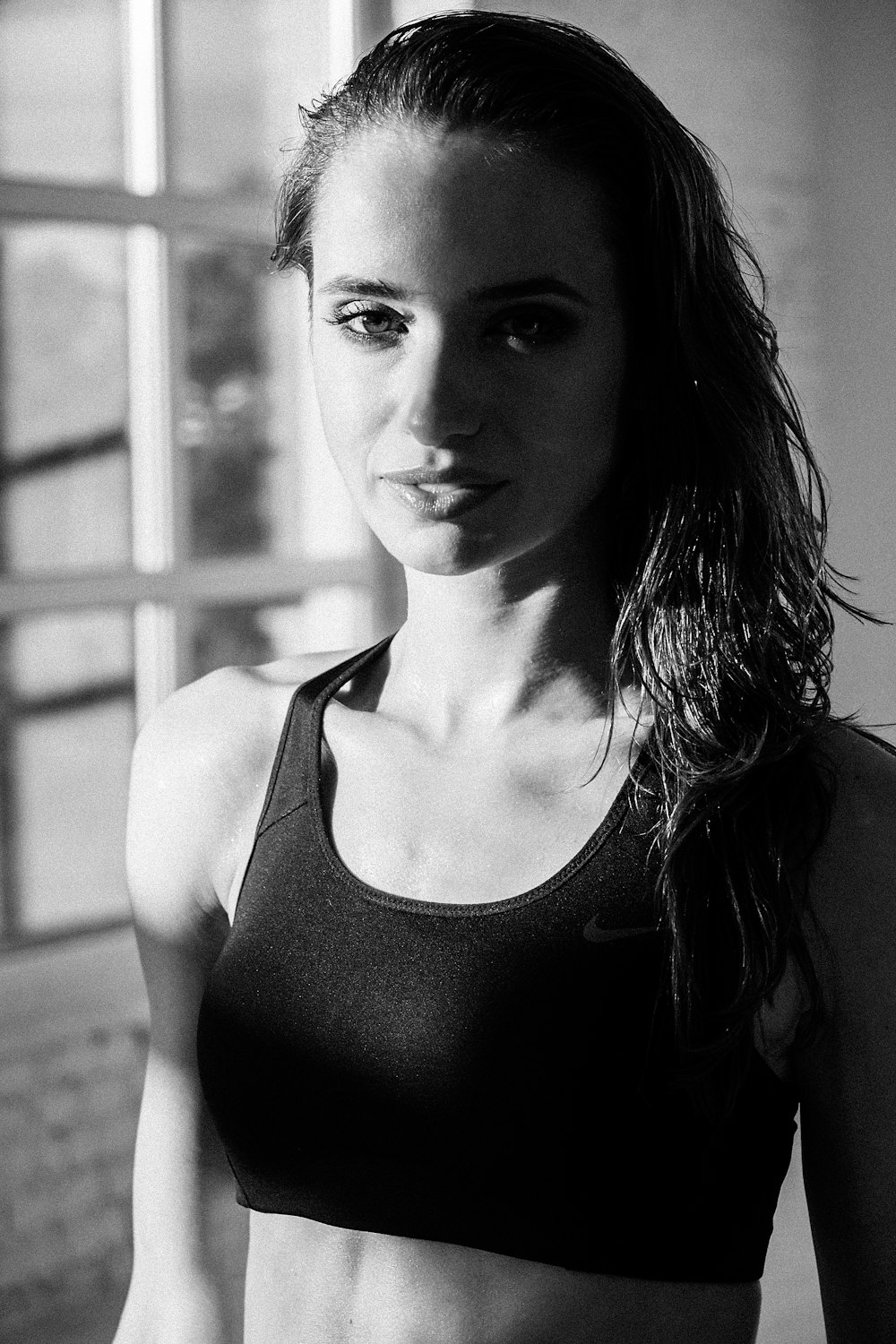 grayscale photography of woman wearing sports bra