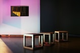 several chairs near white wall