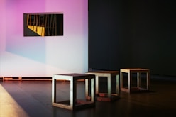 several chairs near white wall