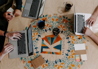 three person using laptops