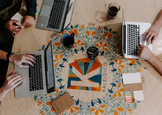 three person using laptops