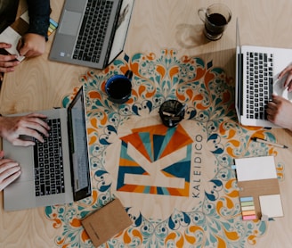 three person using laptops