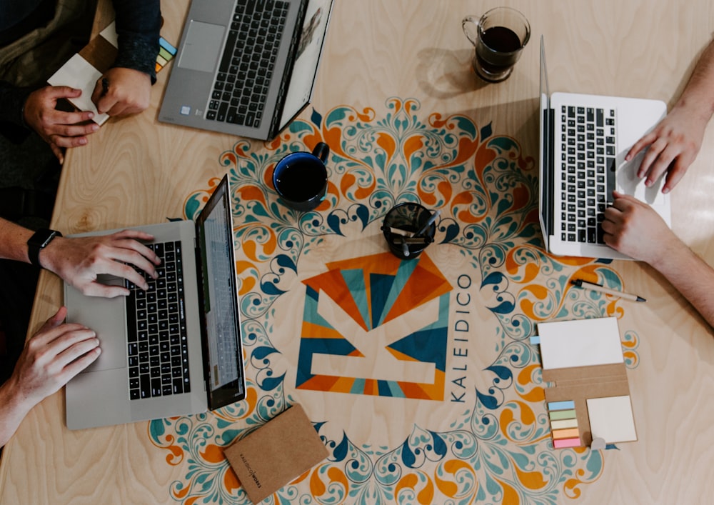 three person using laptops