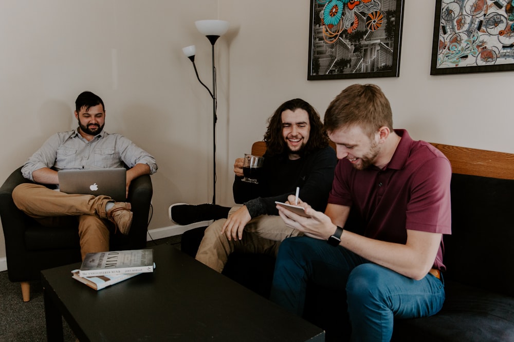 men sitting on sofa