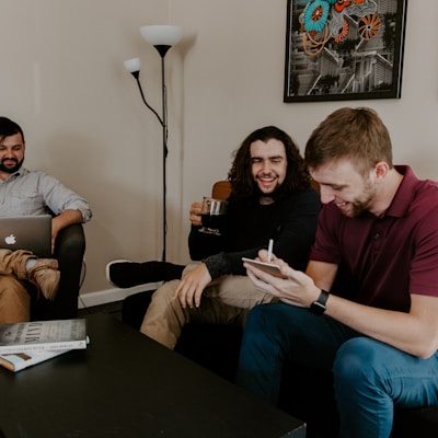 men sitting on sofa