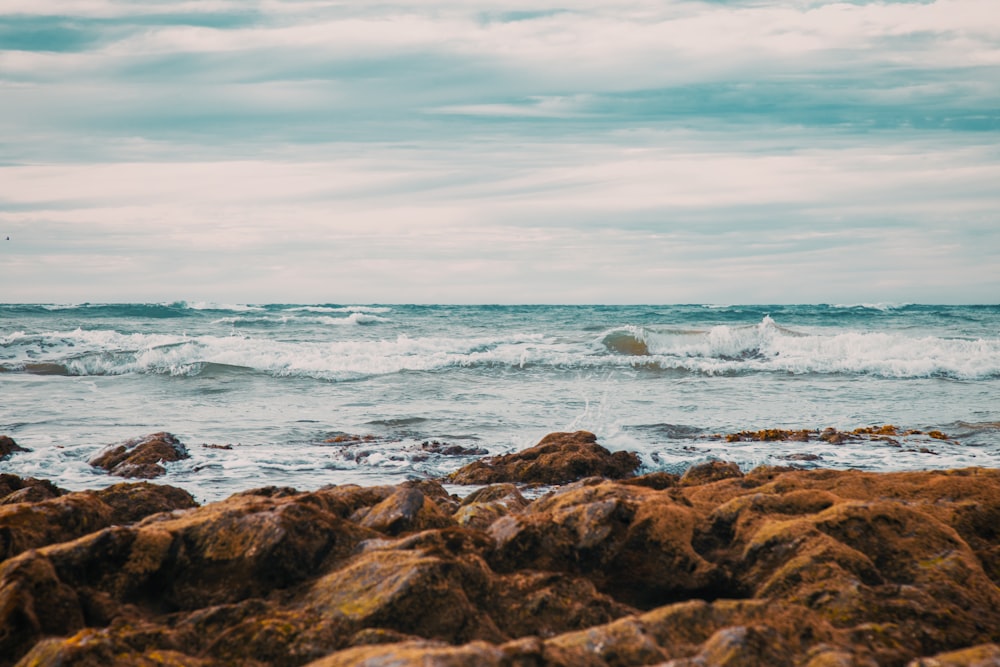 rocky coastline facing rippling body of water