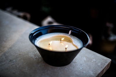 A beautifully crafted stone candle vessel with a warm glow.