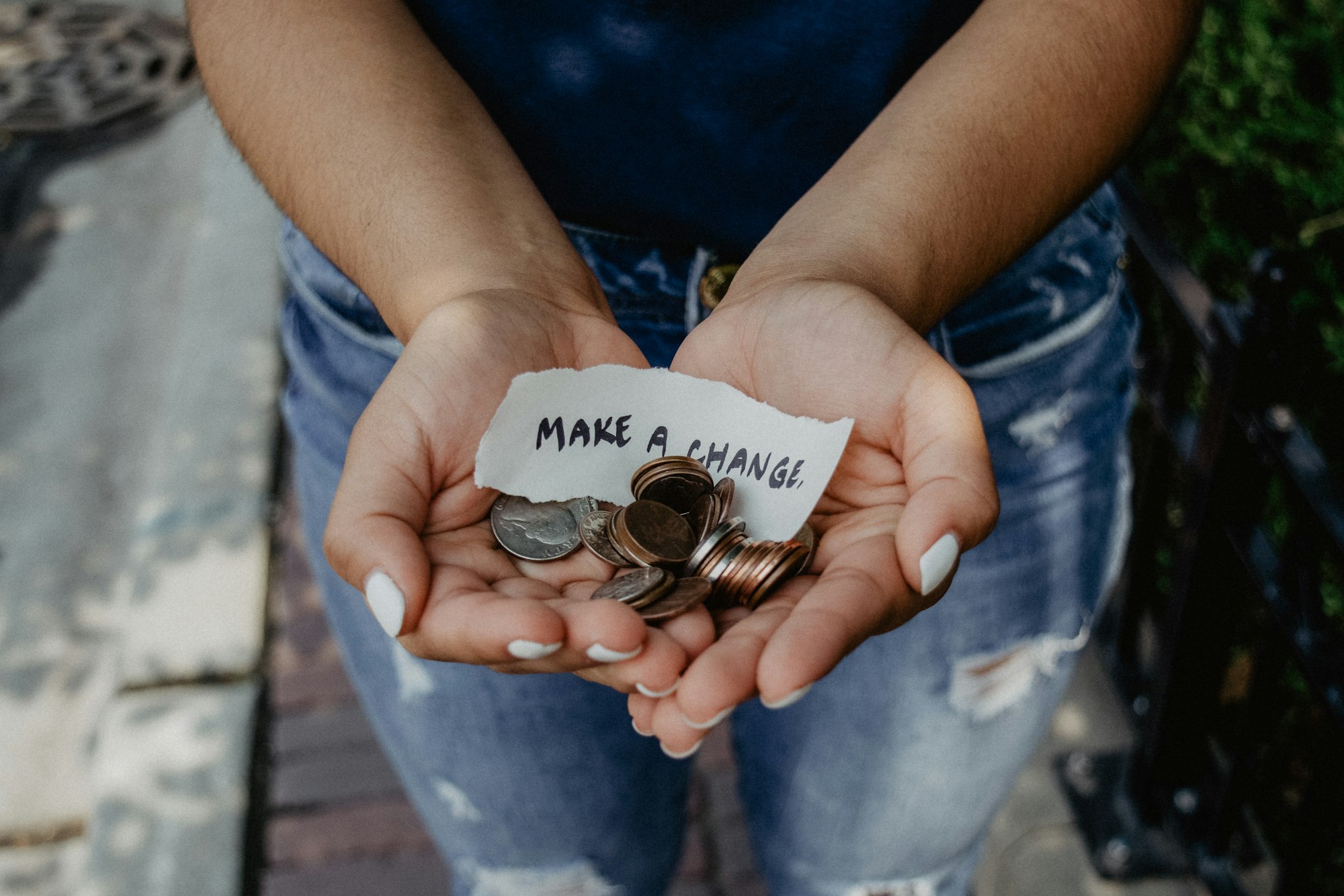 Hands holding change for donations and "make a change" note.