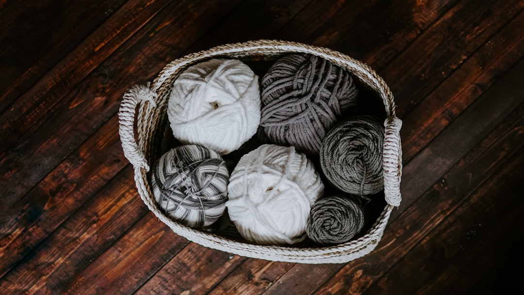 white and brown yarn in basket e