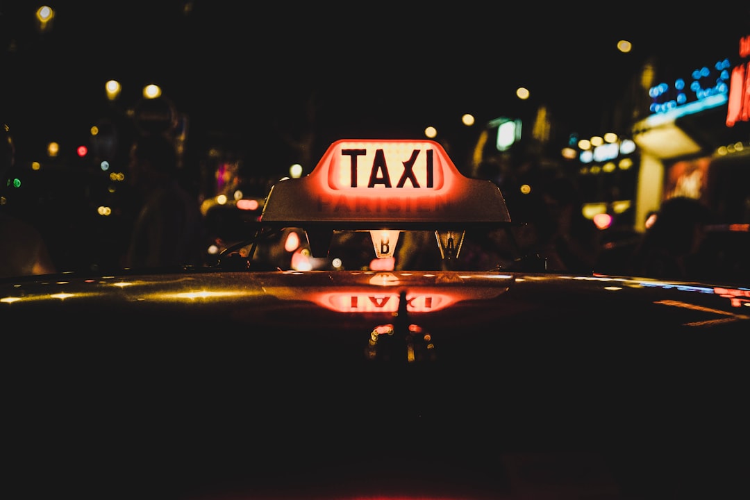 white and red Taxi beaconfield at nighttime