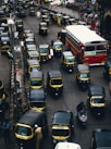 black-and-yellow auto rickshaw on road