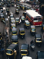 black-and-yellow auto rickshaw on road