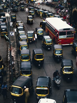 black-and-yellow auto rickshaw on road