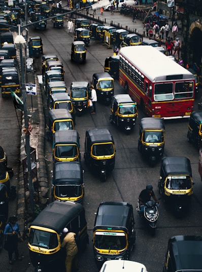 black-and-yellow auto rickshaw on road