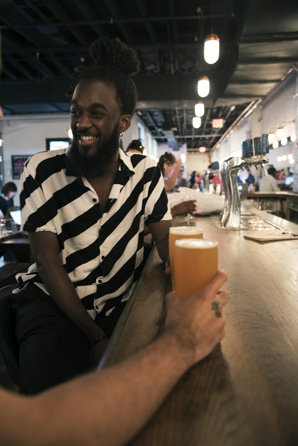 man sitting on stool in bar