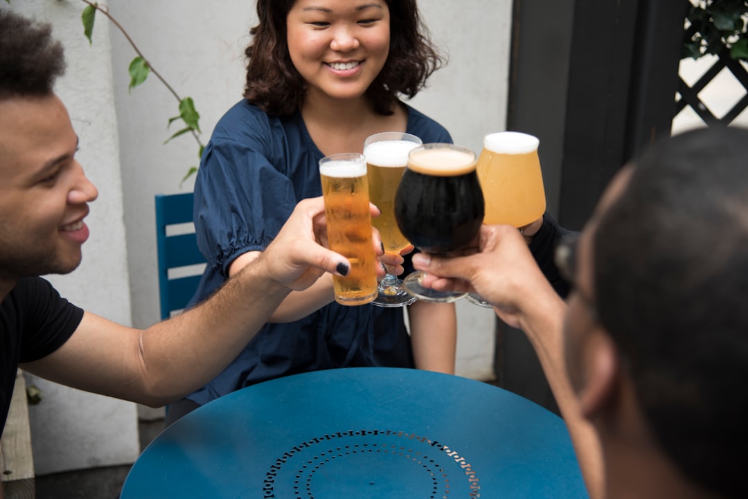 four person's holding wine glasses